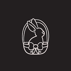 Image showing Easter bunny sitting in basket sketch icon.