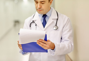 Image showing close up of doctor with clipboard at hospital