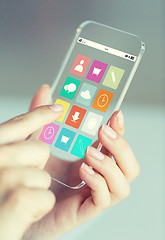 Image showing close up of woman with app icons on smartphone