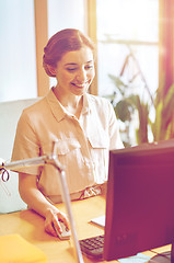 Image showing happy business woman with computer at office