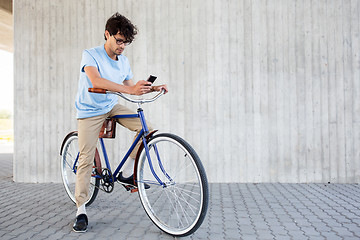 Image showing man with smartphone and fixed gear bike on street