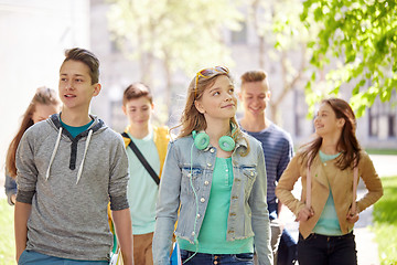 Image showing group of happy teenage students walking outdoors