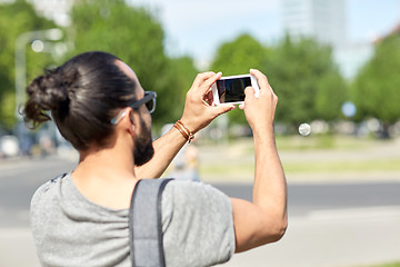 Image showing hipster man taking picture on smartphone