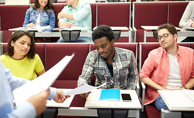 Image showing teacher giving tests to students at lecture