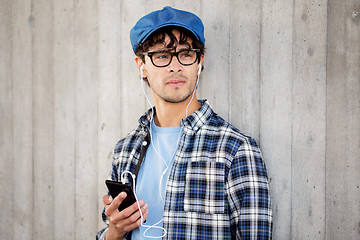 Image showing man with earphones and smartphone listening music