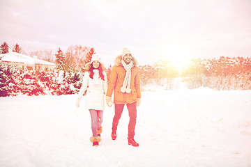 Image showing happy couple walking along snowy winter field