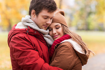 Image showing close up of happy couple hugging in autumn park
