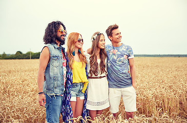 Image showing smiling young hippie friends on cereal field