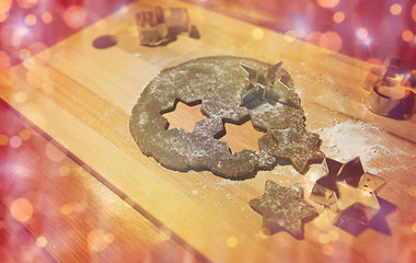 Image showing christmas gingerbread dough and molds on board