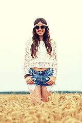 Image showing smiling young hippie woman on cereal field