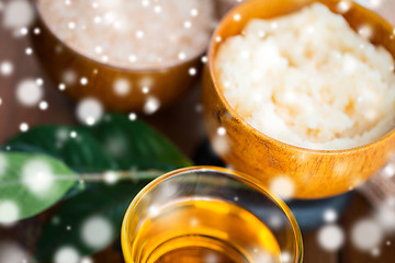 Image showing close up of body scrub in wooden bowl and honey