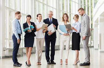 Image showing business team with tablet pc and folders at office