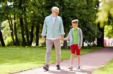 Image showing grandfather and grandson walking at summer park