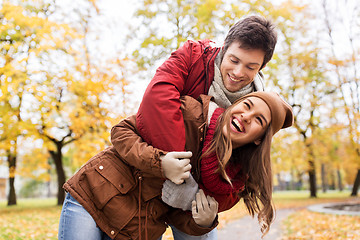 Image showing happy young couple hugging in autumn park