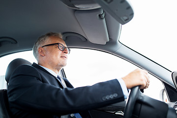 Image showing happy senior businessman driving car