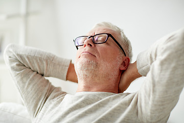 Image showing senior man in glasses relaxing on sofa