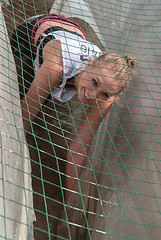 Image showing Girl creeps on an entrenchment with sand and water