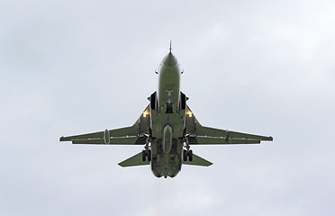 Image showing Military jet bomber Su-24 Fencer flying above the clouds.