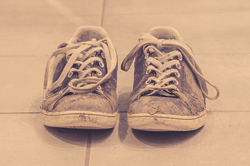 Image showing Muddy shoes in sepia color