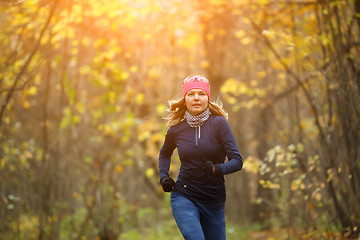 Image showing Girl running among autumn leaves