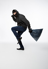 Image showing Thief slinking in black mask