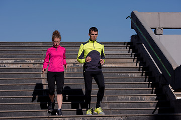 Image showing young  couple jogging on steps