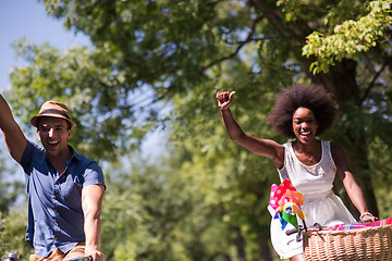 Image showing Young multiethnic couple having a bike ride in nature