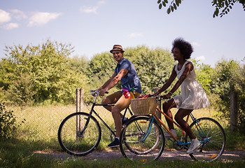 Image showing Young multiethnic couple having a bike ride in nature