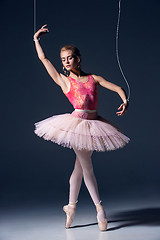 Image showing ballet dancer as puppet dancing over gray background