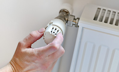 Image showing  Hand Adjusting Heater Thermostat