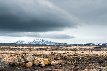 Image showing Rocks on a field with mountains