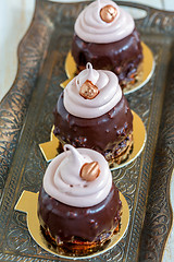 Image showing Cupcakes with chocolate frosting and walnuts.