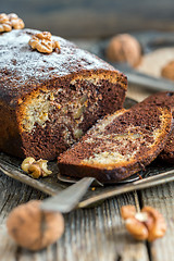 Image showing Homemade chocolate cake with walnuts and orange zest.