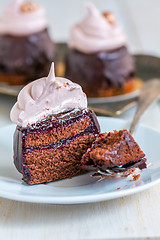 Image showing Slice of chocolate cupcakes with berry confit and Swiss meringue