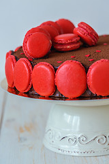 Image showing Chocolate cake decorated with macarons closeup.