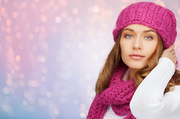 Image showing woman in hat and scarf over pink lights background
