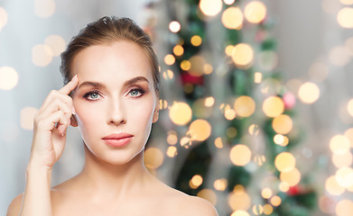 Image showing beautiful woman face over christmas lights