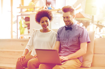 Image showing happy creative team with laptop in office