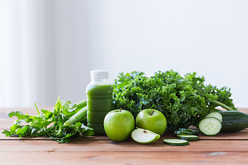 Image showing close up of bottle with green juice and vegetables