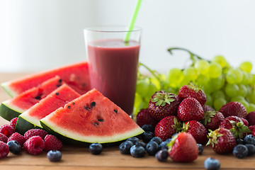 Image showing fruit and berry juice or smoothie on wooden  table