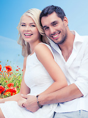 Image showing happy couple having fun over poppy flowers field