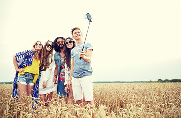 Image showing hippie friends with smartphone on selfie stick