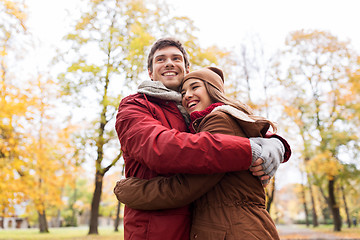 Image showing happy young couple hugging in autumn park