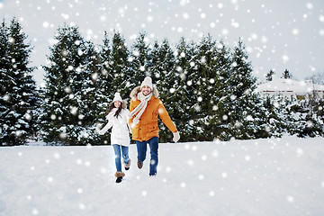 Image showing happy couple running in winter snow