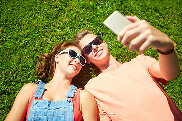 Image showing happy couple taking selfie on smartphone at summer