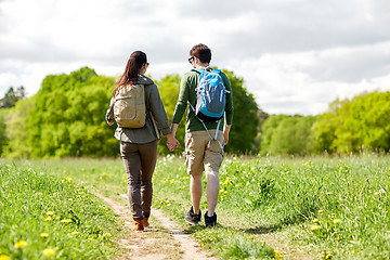 Image showing happy couple with backpacks hiking outdoors