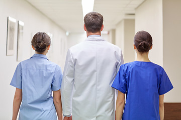 Image showing group of medics or doctors walking along hospital