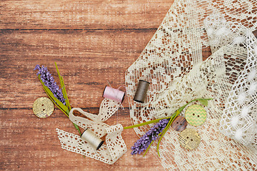 Image showing Lace and thread on wooden background