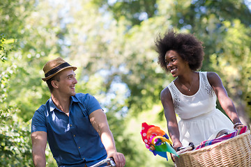 Image showing Young multiethnic couple having a bike ride in nature