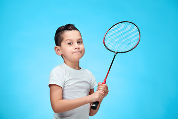Image showing The boy with badminton rackets outdoors